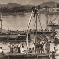 View of body of water with boats, one with pro-American sign.