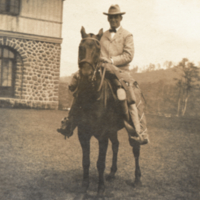 Heiser on horse, wearing hat.