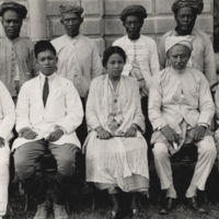 Group portrait of men and women, seated and standing, exterior wall of building in backgound, Zamboanga, 1914.