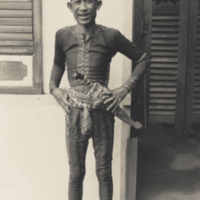 Man from Jolo Province, Philippines, standing outside building.