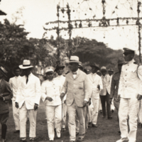 W. Cameron Forbes and group of men walking down dirt road.