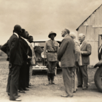 Forbes, White and Vezina of the Haitian Commission, standing outside, cars in background.