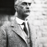 Karl Landsteiner with stone building in background.