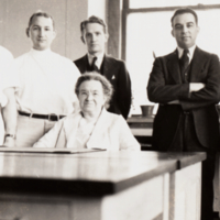 Florence Sabin Seated at Desk with Five Unidentified Men