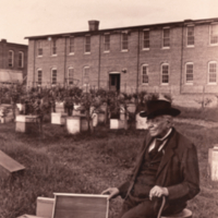 Lorenzo Lorraine Langstroth, full length, informal, seated outside.