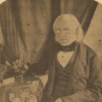 Rubens Peale, sitting at table with microscope.