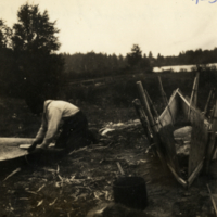 4-36-k: Man constructing a canoe