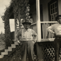 4-39-g: Two men standing in front of a house