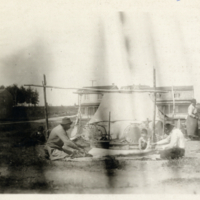 5-29-l: Men, seated, with stretched skins