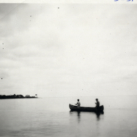 5-31-h: Two men in a canoe on the water