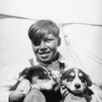 A-016: John Berens, seated, with two puppies