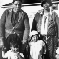 A-033: Ojibwa, Berens River, two women and two children in front of Hudson Bay Company store