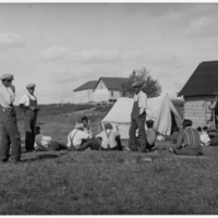 A-087: Ojibwa, Little Grand Rapids, Treaty day, outside log buildings and tent