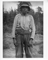 A-279: Ojibwa man, portrait, wearing hat and overalls 