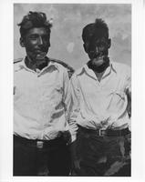 F-121: Ojibwa, Duck Lake, two men in front of Waabano lodge 