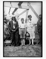 F-284: Four people by wooden structure, portrait