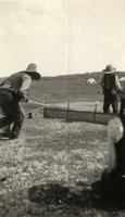 Two Tsuut'ina Indians follow the hoop in the hoop and arrow game