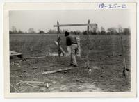 10-25-e: Joseph Pierite, Sr. dressing and drying hide; drying rack