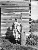 600a: Jemima Gibson, pounding corn with wooden mortar for festival at Onondaga Longhouse