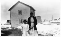 D098: Woman and girl standing outside, Mashteuiatsh