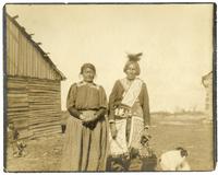 32: Chief of Nett Lake (Bois Forte) Ojibwe and wife, standing