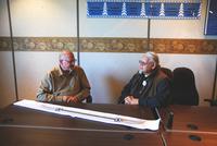 Richard W. Hill, Sr., and Timothy Powell, discussing wampum belt