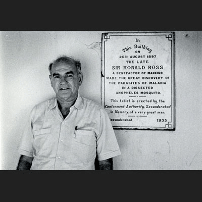 Posing with Sir Ronald Ross plaque in India