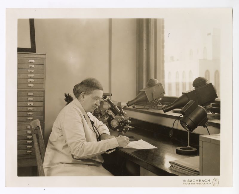 A photograph of Florence Sabin seated with a microscope.