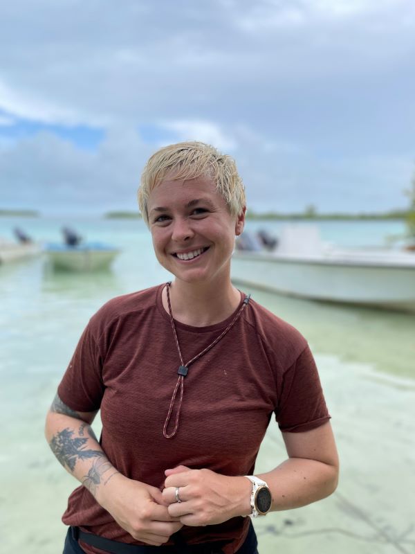 Katrina Sky Munsterman smiling in front of a body of water.